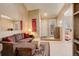 Living area showcasing neutral wall colors, light carpet, and easy access to the front door and additional rooms at 4931 Garrison St # 204G, Wheat Ridge, CO 80033