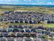Expansive aerial view of a well-planned community with picturesque landscapes and mountain views at 6643 Barnstead Dr, Castle Pines, CO 80108