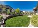 Expansive backyard features lush lawn, retaining wall, and well-maintained landscaping for outdoor enjoyment at 6643 Barnstead Dr, Castle Pines, CO 80108