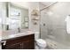 Bathroom featuring a glass shower, dark wood vanity, and neutral walls at 6643 Barnstead Dr, Castle Pines, CO 80108