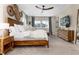 Spacious bedroom with a wooden bed frame, dresser, and ample natural light at 6643 Barnstead Dr, Castle Pines, CO 80108