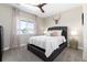 Bedroom with neutral decor, a large window, and a tufted headboard at 6643 Barnstead Dr, Castle Pines, CO 80108