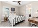 Bedroom with a patterned bedspread, a metal frame bed, and a view to a bathroom at 6643 Barnstead Dr, Castle Pines, CO 80108