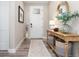 Charming entryway with a wooden console table, decorative mirror, and stylish accents at 6643 Barnstead Dr, Castle Pines, CO 80108