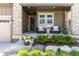 Inviting front porch with comfortable seating, landscaping, and stone accents at 6643 Barnstead Dr, Castle Pines, CO 80108