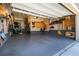 An organized garage with epoxy flooring, storage cabinets, and ample space at 6643 Barnstead Dr, Castle Pines, CO 80108