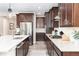 Modern kitchen features stainless steel appliances, dark cabinets, and white countertops at 6643 Barnstead Dr, Castle Pines, CO 80108