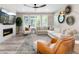 Cozy living room with a fireplace, large windows, and comfortable seating area at 6643 Barnstead Dr, Castle Pines, CO 80108