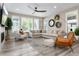 Bright and airy living room with modern furniture, fireplace, and ample seating at 6643 Barnstead Dr, Castle Pines, CO 80108