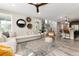 Bright living room features a large sectional sofa, stylish decor, and lots of natural light at 6643 Barnstead Dr, Castle Pines, CO 80108