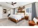 A spacious main bedroom with hardwood floors, a ceiling fan, and natural lighting at 6643 Barnstead Dr, Castle Pines, CO 80108