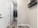 Bright mud room with wood floors, a coat rack, and closet space at 6643 Barnstead Dr, Castle Pines, CO 80108
