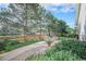 This backyard features a paved patio, green grass, a garden, a wooden fence, and tall trees at 16929 W 63Rd Ln, Golden, CO 80403