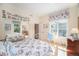 Charming bedroom featuring floral bedding, mirror closet doors and bright natural light from a window at 16929 W 63Rd Ln, Golden, CO 80403