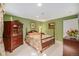 Cozy bedroom with green walls, dark wood furniture, and a four-poster bed at 16929 W 63Rd Ln, Golden, CO 80403