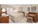 Bright and inviting bedroom with floral bedding, a vintage desk, and ample natural light at 16929 W 63Rd Ln, Golden, CO 80403