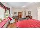 Spacious bedroom features a window seat, floral furnishings, and hardwood floors at 16929 W 63Rd Ln, Golden, CO 80403