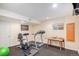 Compact gym featuring a treadmill, exercise bike, small table, and neutral walls at 16929 W 63Rd Ln, Golden, CO 80403