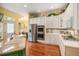 Bright kitchen features white cabinets, stainless steel appliances, and hardwood floors at 16929 W 63Rd Ln, Golden, CO 80403