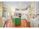 Bright kitchen features a green central island, white cabinets, and modern stainless steel appliances at 16929 W 63Rd Ln, Golden, CO 80403