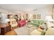 Open-concept living room with hardwood floors and an abundance of comfortable seating at 16929 W 63Rd Ln, Golden, CO 80403