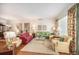 Spacious living room with comfortable seating, floral accents, and hardwood flooring at 16929 W 63Rd Ln, Golden, CO 80403