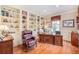 Home office with built-in bookshelves, a large desk, and comfortable seating at 16929 W 63Rd Ln, Golden, CO 80403