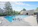 Community pool with children swimming, surrounded by lounge chairs and a nearby recreation building at 16929 W 63Rd Ln, Golden, CO 80403