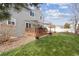 House backyard with deck, grass, and gravel landscaping at 6370 Wolff St, Arvada, CO 80003