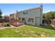 Backyard view of a two-story home featuring a deck, lawn, and fenced yard, ideal for outdoor enjoyment at 20396 E Berry Pl, Centennial, CO 80015