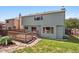 A charming backyard view featuring a wooden deck and a well-maintained grassy area, perfect for outdoor relaxation and entertainment at 20396 E Berry Pl, Centennial, CO 80015