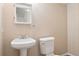 A clean bathroom features a white sink, toilet, and mirror creating a tidy and functional space at 20396 E Berry Pl, Centennial, CO 80015