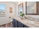Bright bathroom with double vanity, stylish mirrors, and wood-look tile flooring at 20396 E Berry Pl, Centennial, CO 80015