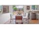 Bright dining area with sliding door access to deck, modern furnishings, and hardwood floors at 20396 E Berry Pl, Centennial, CO 80015