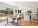 Modern kitchen with an island, stainless steel appliances, granite countertops, and an adjacent dining area at 20396 E Berry Pl, Centennial, CO 80015