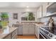 Bright kitchen with granite countertops, stainless steel appliances, and a view to the backyard at 20396 E Berry Pl, Centennial, CO 80015