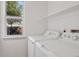 Bright laundry room featuring a side-by-side washer and dryer and natural light from a window at 20396 E Berry Pl, Centennial, CO 80015