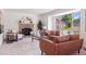 Bright and airy living room with a cozy brick fireplace, large windows, and stylish furnishings at 20396 E Berry Pl, Centennial, CO 80015