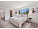 Serene main bedroom with a large window, neutral color palette, and a spacious walk-in closet at 20396 E Berry Pl, Centennial, CO 80015