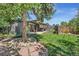 Landscaped backyard with patio and stone pathway at 658 Poplar St, Denver, CO 80220