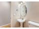 Charming bathroom with pedestal sink, oval mirror, and new toilet at 20431 E Union Cir, Aurora, CO 80015
