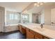 Bright Primary bathroom featuring a double sink vanity, soaking tub, and separate shower at 20431 E Union Cir, Aurora, CO 80015