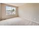 This bedroom is carpeted with a large window at 20431 E Union Cir, Aurora, CO 80015