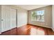 This room showcases hardwood floors, a window, and a double door closet at 20431 E Union Cir, Aurora, CO 80015