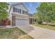 Charming two-story home with a large garage, brick accents, and well-manicured landscaping at 20431 E Union Cir, Aurora, CO 80015
