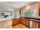 Stylish kitchen with wooden cabinets, granite countertops, hardwood floors, and stainless steel appliances at 20431 E Union Cir, Aurora, CO 80015
