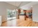 Cozy kitchen with hardwood floors, wooden cabinets, and sliding glass doors leading to a patio or deck at 20431 E Union Cir, Aurora, CO 80015