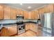 Bright kitchen with stainless steel appliances, light wood cabinetry, and hardwood floors at 20431 E Union Cir, Aurora, CO 80015