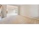 Spacious, carpeted living room area with natural light, neutral colors, and stairs in the background at 20431 E Union Cir, Aurora, CO 80015