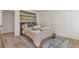 Well-lit bedroom with neutral tones, a wooden bed frame, and a sliding door closet at 3733 W 97Th Ave, Westminster, CO 80031